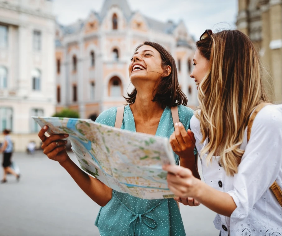 Two women looking at a map in a foreign city